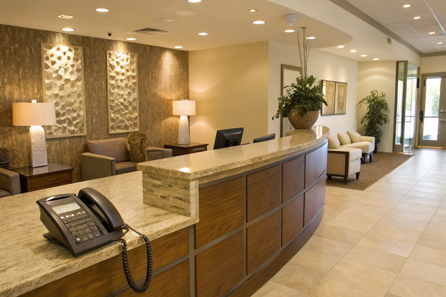 Empty med-spa reception with ringing phone, modern decor.