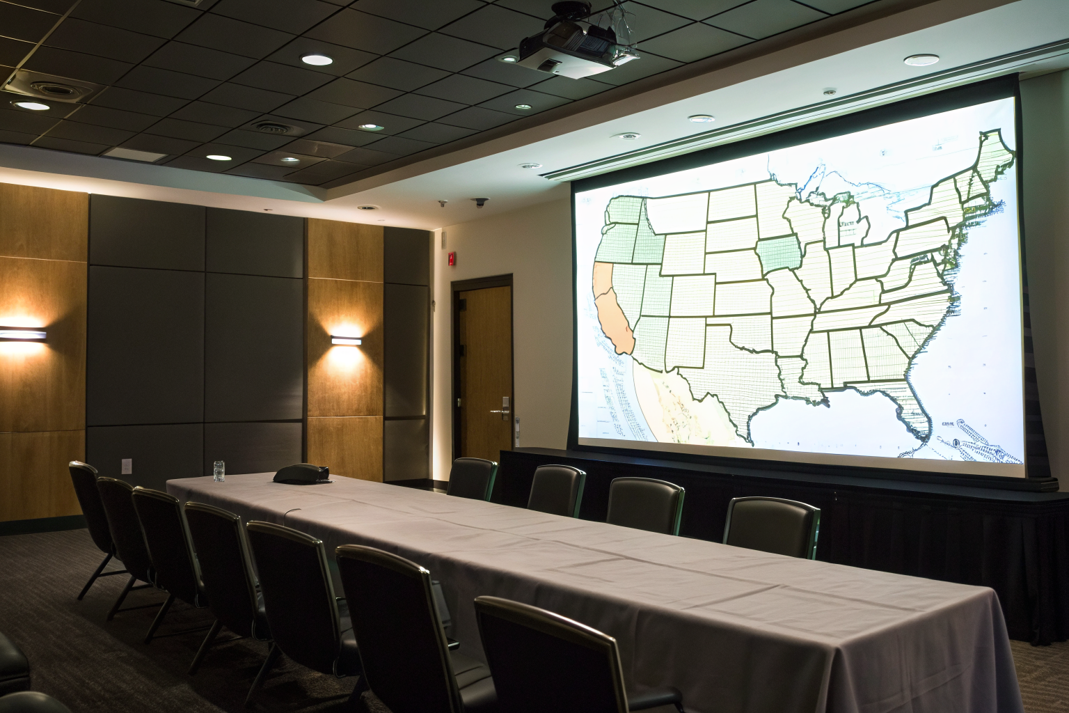 US map highlighting Arizona in a conference room setting.