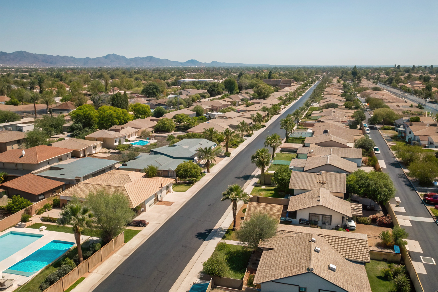 Phoenix street with many houses, each having a backyard pool.