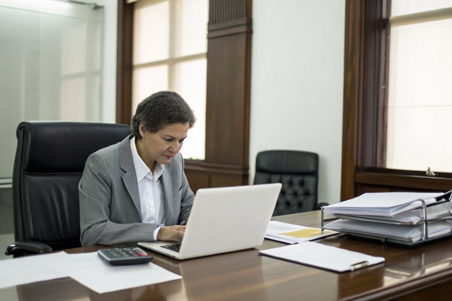 Person examining 10DLC registration costs on laptop.