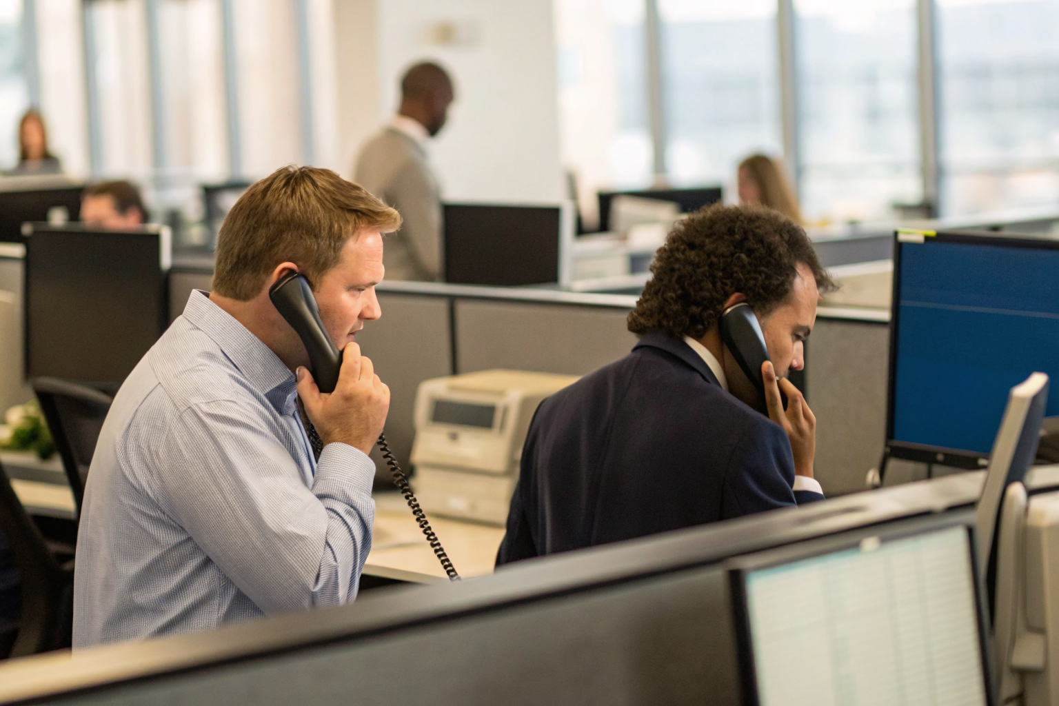 Two businesses answering calls, focus on fast response, tech setup.