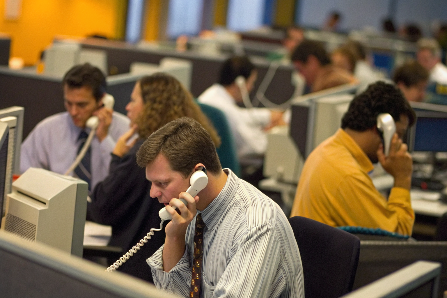 Busy Peoria office with employees answering phone calls.