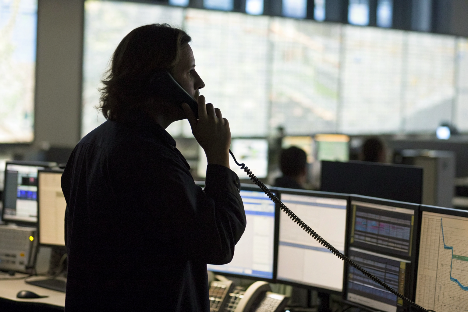 Person answering phone in office, multiple call logs.