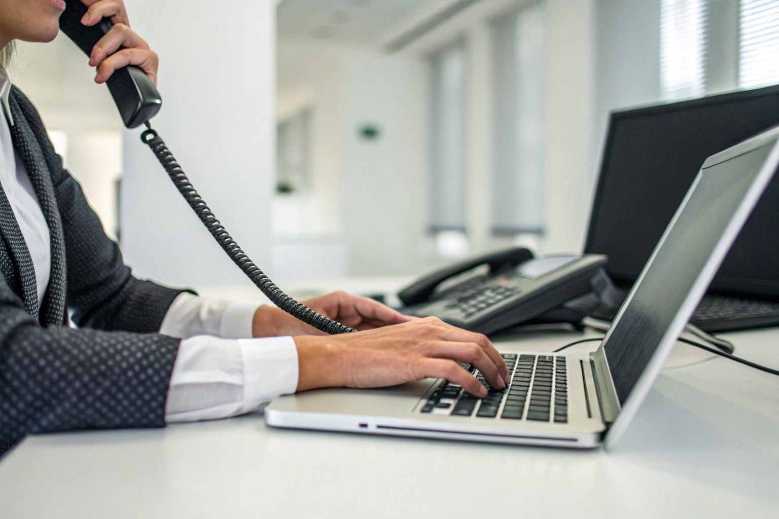 Person hanging up and searching for competitors on a computer.