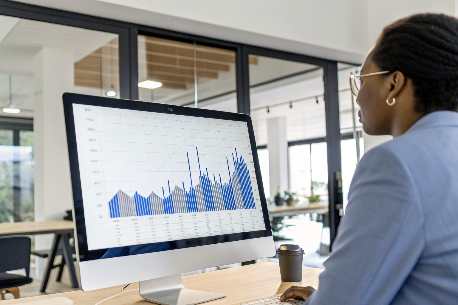 Graph of HVAC call spikes on screen with person analyzing in office.