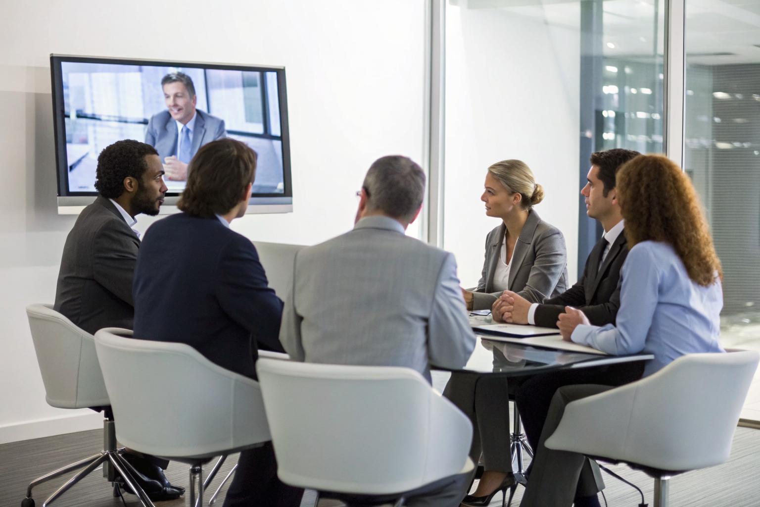 Business meeting discussing vendor selection framework with digital display.
